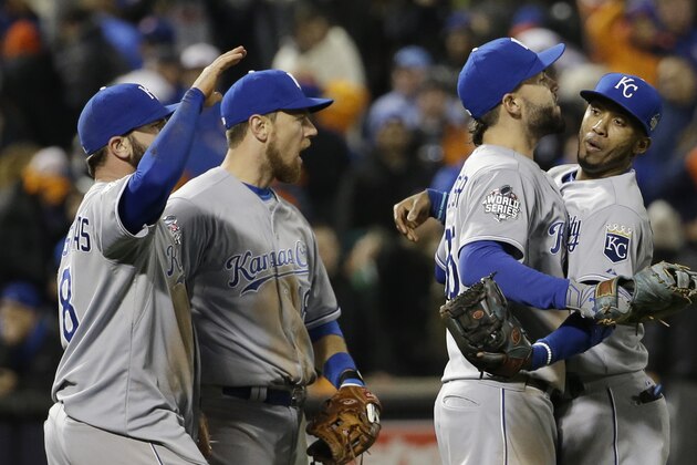 Kansas City Royals' Alcides Escobar, Eric Hosmer, Mike Moustakas and Ben Zobrist celebrate after Game 4 of the Major League Baseball World Series against the New York Mets Saturday, Oct. 31, 2015, in New York. The Royals won 5-3 to take a 3-1 lead in the series. (AP Photo/David J. Phillip)