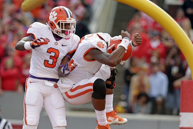 Clemson's Artavis Scott (3) and quarterback Deshaun Watson celebrate Watson's touchdown against North Carolina State during the first half of an NCAA college football game in Raleigh, N.C., Saturday, Oct. 31, 2015. Clemson won 56-41. (AP Photo/Gerry Broome)