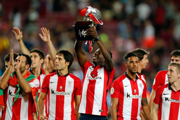 Athletic Bilbao's Inaki Williams lifts the trophy at the end of  a second leg Spanish Super Cup soccer match between FC Barcelona and Athletic Bilbao at the Camp Nou stadium in Barcelona, Spain, Monday, Aug.17, 2015. After a 1-1 draw Athletic Bilbao won the trophy following the first leg 4-0 win. (AP Photo/Manu Fernandez)