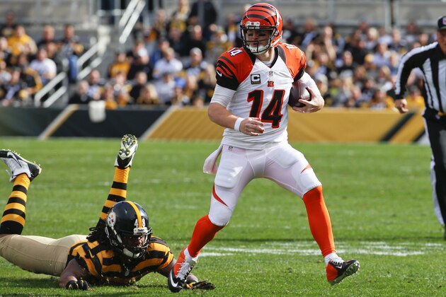 Cincinnati Bengals quarterback Andy Dalton (14) scrambles away from Pittsburgh Steelers linebacker Bud Dupree (48) in the first quarter of an NFL football game against the Cincinnati Bengals, Sunday, Nov. 1, 2015 in Pittsburgh. (AP Photo/Gene J. Puskar)