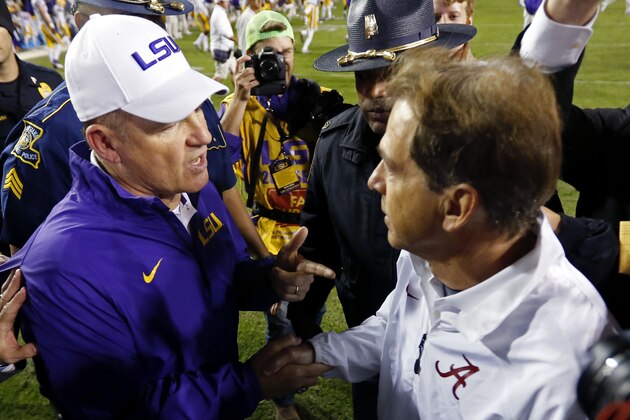 LSU coach Les Miles, left, shakes hands with Alabama coach Nick Saban after an NCAA college football game in Baton Rouge, La., Saturday, Nov. 8, 2014. Alabama won in overtime, 20-13. (AP Photo/Jonathan Bachman)