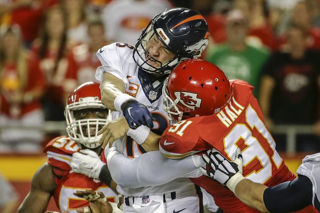 Kansas City Chiefs linebacker Tamba Hali (91)] makes contact with Denver Broncos quarterback Peyton Manning (18) after the throw, in the first half of an NFL football game in Kansas City, Mo., Thursday, Sept. 17, 2015. (AP Photo/Charlie Riedel)