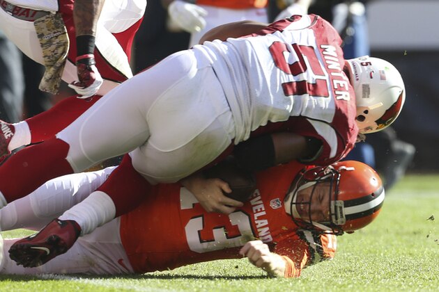 Cleveland Browns quarterback Josh McCown (13) is tackled by Arizona Cardinals middle linebacker Kevin Minter (51) in the first half of an NFL football game, Sunday, Nov. 1, 2015, in Cleveland. (AP Photo/Ron Schwane)