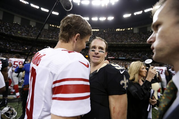 New York Giants quarterback Eli Manning (10) and New Orleans Saints quarterback Drew Brees (9) greet each other after an NFL football game in New Orleans, Sunday, Nov. 1, 2015.  The Saints won 52-49. (AP Photo/Butch Dill)