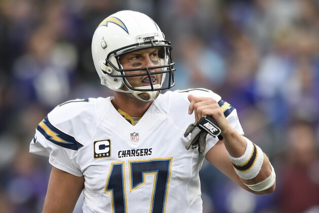 San Diego Chargers quarterback Philip Rivers (17) watch the replay of wide receiver Malcom Floyd's touchdown as he walks off the field during the second half of an NFL football game in Baltimore, Sunday, Nov. 1, 2015. (AP Photo/Gail Burton)