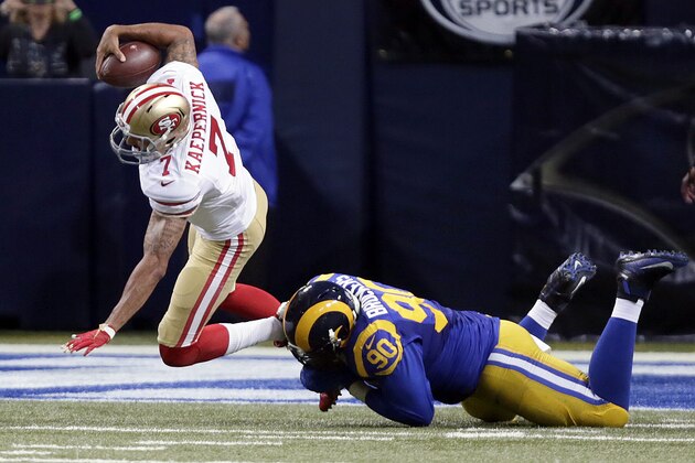 San Francisco 49ers quarterback Colin Kaepernick, left, is sacked for a 3-yard loss by St. Louis Rams defensive tackle Michael Brockers during the second quarter of an NFL football game Sunday, Nov. 1, 2015, in St. Louis. (AP Photo/Tom Gannam)