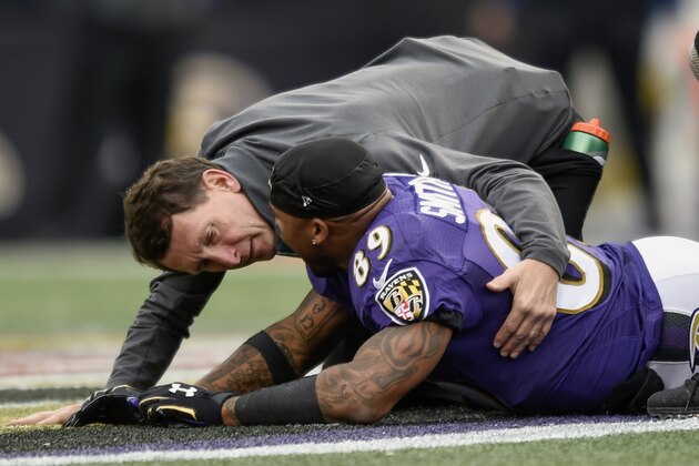 A trainer tends to Baltimore Ravens wide receiver Steve Smith (89) after an injury during the second half of an NFL football game against the San Diego Chargers in Baltimore, Sunday, Nov. 1, 2015. The Ravens defeated the Chargers 29-26. (AP Photo/Gail Burton)