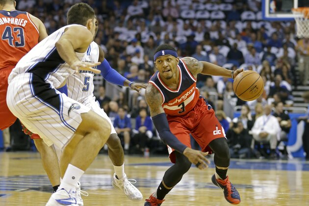 Washington Wizards guard Bradley Beal, right, looks to get around Orlando Magic center Nikola Vucevic, left, during the first half of an NBA basketball game, Wednesday, Oct. 28, 2015, in Orlando, Fla. (AP Photo/John Raoux)