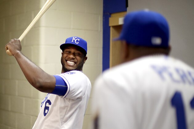 Kansas City Royals' Lorenzo Cain (6) laughs with Salvador Perez as Cain poses for a photo during the team's photo day Friday, Feb. 27, 2015, in Surprise, Ariz. (AP Photo/Charlie Riedel)