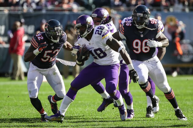 CHICAGO, IL - NOVEMBER 01:   Adrian Peterson #28 of the Minnesota Vikings carries the football against  LaRoy Reynolds #52 and  Jarvis Jenkins #96 of the Chicago Bears in the second quarter at Soldier Field on November 1, 2015 in Chicago, Illinois.  (Photo by Jonathan Daniel/Getty Images)