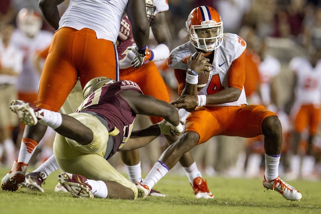 Clemson quarterback Deshaun Watson, right, escapes a sack from Florida State defensive tackle Eddie Goldman in the second half of an NCAA college football game in Tallahassee, Fla., Saturday, Sept. 20, 2014.  Florida State won 23-17 in overtime. (AP Photo/Mark Wallheiser)
