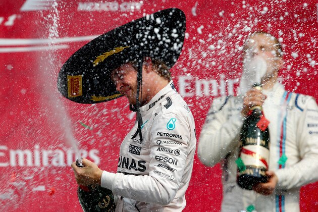 MEXICO CITY, MEXICO - NOVEMBER 01:  Nico Rosberg of Germany and Mercedes GP celebrates on the podium next to Valtteri Bottas of Finland and Williams after winning the Formula One Grand Prix of Mexico at Autodromo Hermanos Rodriguez  on November 1, 2015 in Mexico City, Mexico.  (Photo by Mark Thompson/Getty Images)