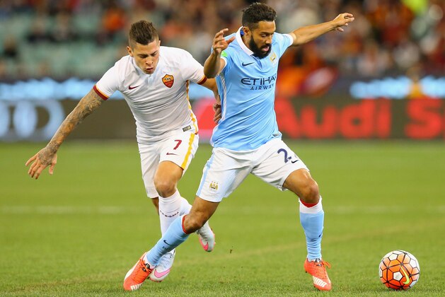 MELBOURNE, AUSTRALIA - JULY 21:  Juan Manuel Iturbe of AS Roma and Gael Clichy of Manchester City compete for the ball during the International Champions Cup friendly match between Manchester City and AS Roma at the Melbourne Cricket Ground on July 21, 2015 in Melbourne, Australia.  (Photo by Quinn Rooney/Getty Images)
