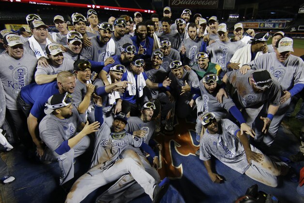 Kansas City Royals pose with World Series trophy after Game 5 of the Major League Baseball World Series against the New York Mets Monday, Nov. 2, 2015, in New York. The Royals won 7-2 to win the series. (AP Photo/Matt Slocum)