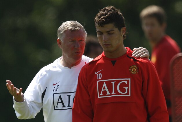 Manchester United's Cristiano Ronaldo, right, walks from the pitch accompanied by his manager Alex Ferguson after a practice session at Carrington training ground in Manchester, England, Thursday May 15, 2008. Manchester United will play Chelsea in the Champion's League final soccer match at the Luzhniki Stadium in Moscow on May 21. (AP Photo/Jon Super)