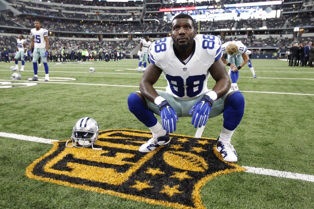 Dallas Cowboys' Dez Bryant (88) stretches on the gold NFL logo before a football game against the Seattle Seahawks Sunday, Nov. 1, 2015, in Arlington, Texas. (AP Photo/Brandon Wade)