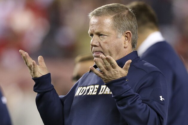 Notre Dame head coach Brian Kelly gestures to his players as they warm up before an NCAA college football game against Temple  Saturday, Oct. 31, 2015, in Philadelphia. (AP Photo/Mel Evans)