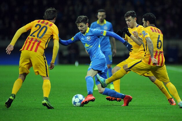 BATE Borisov's Serbian defender Filip Mladenovic (C) vies for the ball with (from L) Barcelona's midfielder Sergi Roberto, Barcelona's forward Munir El Haddadi and Barcelona's Brazilian defender Dani Alves during the UEFA Champions League group E football match between FC BATE Borisov and FC Barcelona at the Borisov Arena stadium outside Minsk on October 20, 2015. AFP PHOTO / SERGEI GAPON        (Photo credit should read SERGEI GAPON/AFP/Getty Images)