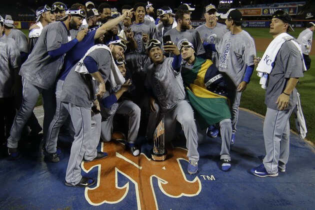 Kansas City Royals pose with World Series trophy after Game 5 of the Major League Baseball World Series against the New York Mets Monday, Nov. 2, 2015, in New York. The Royals won 7-2 to win the series. (AP Photo/Matt Slocum)