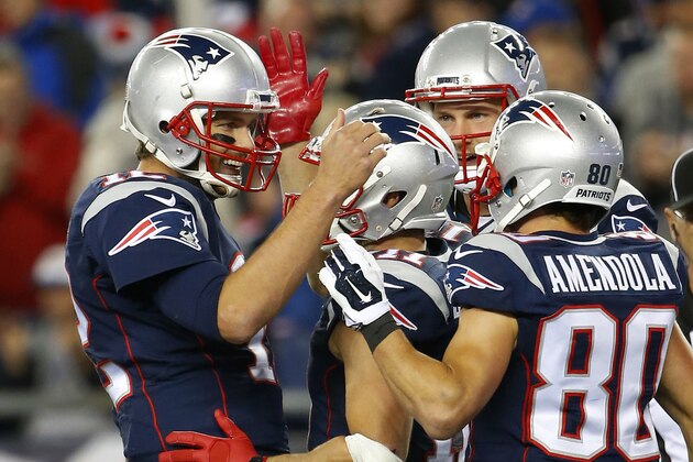 New England Patriots quarterback Tom Brady celebrates a touchdown against the Miami Dolphins with wide receiver Danny Amendola (80) and Julian Edelman during a NFL football game at Gillette Stadium in Foxborough, Mass. Thursday, Oct. 29, 2015. (Winslow Townson/AP Images for Panini)