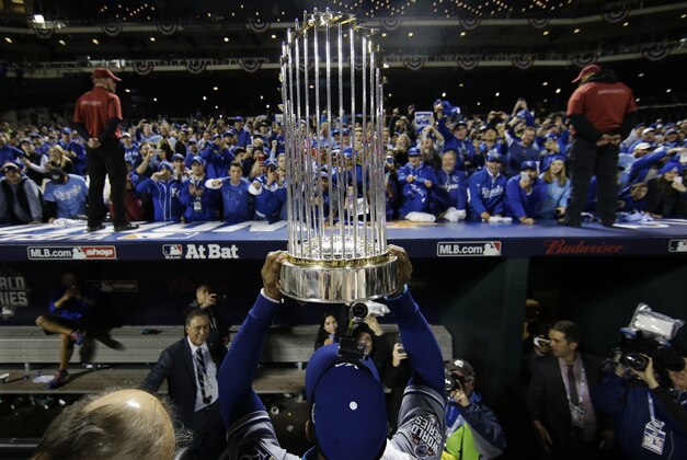 Kansas City Royals' Jarrod Dyson holds the World Series trophy after Game 5 of the Major League Baseball World Series against the New York Mets Monday, Nov. 2, 2015, in New York. The Royals won 7-2 to win the series. (AP Photo/Matt Slocum)