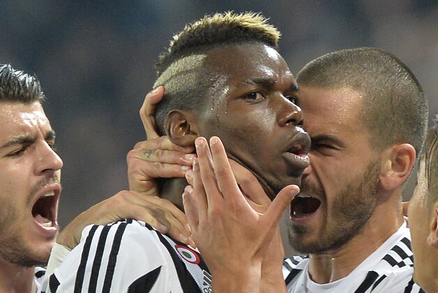 Juventus' Paul Pogba, center, celebrates with his teammates after scoring during a Serie A soccer match between Juventus and Torino at the Juventus stadium, in Turin, Italy, Saturday, Oct. 31, 2015. (AP Photo/ Massimo Pinca)