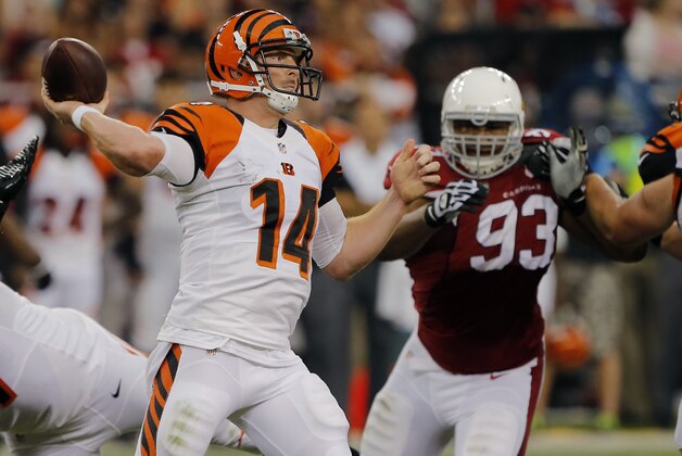 Cincinnati Bengals quarterback Andy Dalton (14) throws as Arizona Cardinals defensive end Calais Campbell (93) pursues during the first half of an NFL preseason football game, Sunday, Aug. 24, 2014, in Glendale, Ariz. (AP Photo/Rick Scuteri)