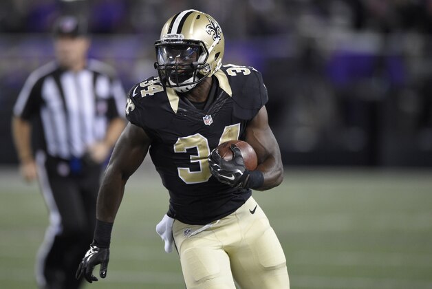 New Orleans Saints running back Tim Hightower (34) runs with the ball against the Baltimore Ravens during an NFL preseason football game, Thursday, Aug. 13, 2015, in Baltimore. (AP Photo/Nick Wass)
