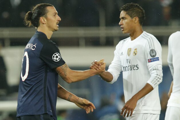 PSG's Zlatan Ibrahimovic, left,  is congratulated by Real Madrid's Raphael Varane at the end of the Champions League group A soccer match against Paris St Germain at the Parc des Princes stadium in Paris, Wednesday, Oct. 21, 2015. Cristiano Ronaldo could not find the target for Real Madrid and Zlatan Ibrahimovic had an even less impressive performance for Paris Saint-Germain as the Group A leaders drew 0-0 in the Champions League on Wednesday. (AP Photo/Michel Euler)