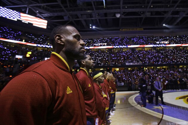Cleveland Cavaliers' LeBron James listens during the national anthem before an NBA basketball game between the Miami Heat and the Cleveland Cavaliers, Friday, Oct. 30, 2015, in Cleveland. (AP Photo/Tony Dejak)