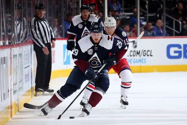 DENVER, CO - OCTOBER 24:  Nathan MacKinnon #29 of the Colorado Avalanche controls the puck against Cam Atkinson #13 of the Columbus Blue Jackets at Pepsi Center on October 24, 2015 in Denver, Colorado. The Blue Jackets defeated the Avalanche 4-3.  (Photo by Doug Pensinger/Getty Images)