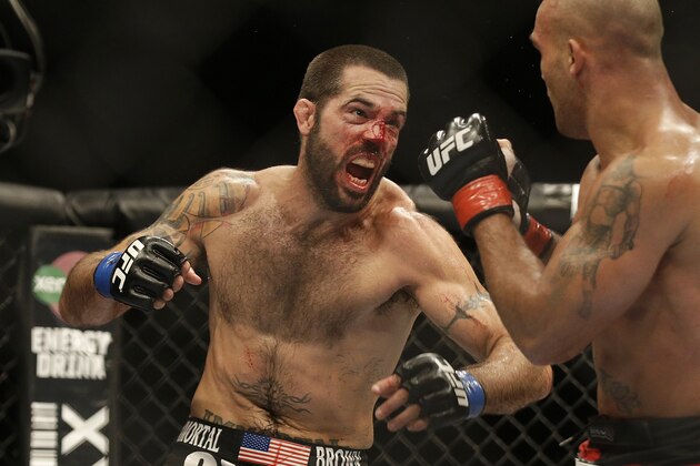 Matt Brown, left, throws a punch at Robbie Lawler  during the fifth round of a welterweight mixed martial arts bout at a UFC on Fox event in San Jose, Calif., Saturday, July 26, 2014. Lawler won by unanimous decision. (AP Photo/Jeff Chiu)