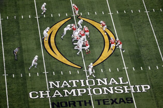FILE - In this Jan. 12, 2015, file photo, Ohio State, right, and Oregon play during the first half of the NCAA college football playoff championship game in Arlington, Texas. According to an NCAA report to be released Tuesday, April 14, 2015, the 39 postseason FBS games distributed $505.9 million to the participating conferences and schools. The schools spent $100.2 million to take part in bowl games. The increase in payouts is due mostly to the increased value of media deals with the seven games, six bowls and a national championship game, that are part of the College Football Playoff. (AP Photo/Tony Gutierrez, File)