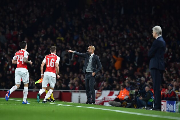Arsenal's French manager Arsene Wenger (R) watches as Bayern Munich's Spanish head coach Pep Guardiola (C) gestures to his players during the UEFA Champions League football match between Arsenal and Bayern Munich at the Emirates Stadium in London, on October 20, 2015.    AFP PHOTO / BEN STANSALL        (Photo credit should read BEN STANSALL/AFP/Getty Images)
