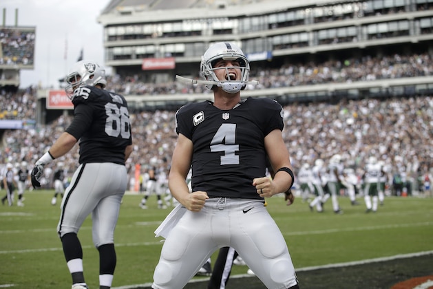 Oakland Raiders quarterback Derek Carr (4) reacts after throwing a touchdown pass to wide receiver Andre Holmes during the first half of an NFL football game against the New York Jets in Oakland, Calif., Sunday, Nov. 1, 2015. (AP Photo/Marcio Jose Sanchez)