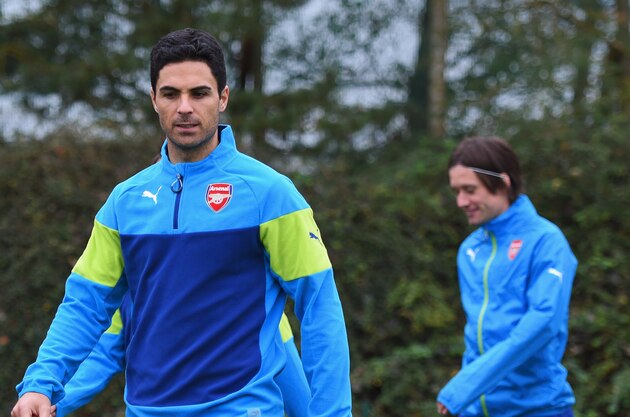 ST ALBANS, ENGLAND - NOVEMBER 03:  (L-R) Serge Gnabry, Mikel Arteta and Tomas Rosicky look on during an Arsenal training session ahead of the UEFA Champions League match against RSC Anderlecht at London Colney on November 3, 2014 in St Albans, England.  (Photo by Michael Regan/Getty Images)