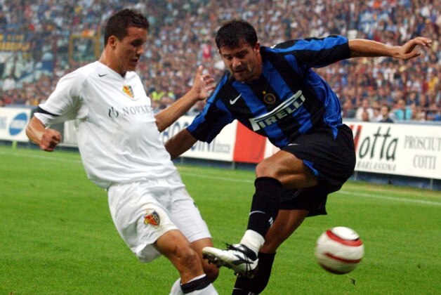 Inter Milan midfielder Dejan Stankovic, right, of Yugoslavia and Basel midfielder Philipp Degen challenge for the ball during their Champions League third qualifying, second leg, soccer match at the San Siro stadium in Milan, Italy, Tuesday, Aug 24, 2004. (AP Photo/Antonio Calanni)