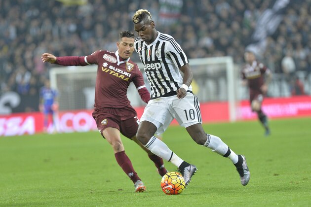 Juventus' Paul Pogba challenges for the ball with Torino Giuseppe Vives during a Serie A soccer match between Juventus and Torino at the Juventus stadium, in Turin, Italy, Saturday, Oct. 31, 2015. (AP Photo/ Massimo Pinca)
