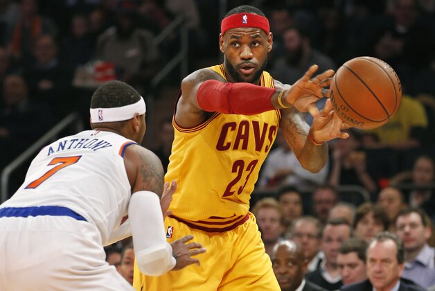 Cleveland Cavaliers forward LeBron James (23) passes around New York Knicks forward Carmelo Anthony (7) in the first half of an NBA basketball game in New York, Thursday, Dec. 4, 2014. (AP Photo/Kathy Willens)