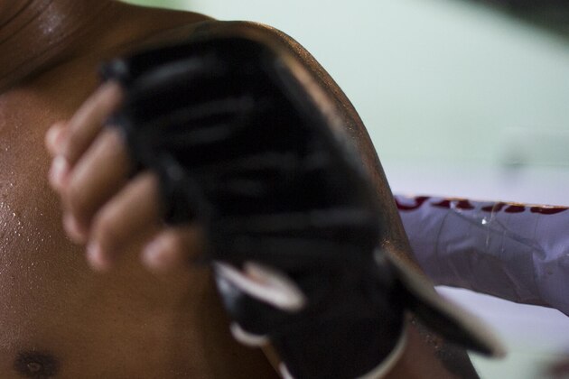 TO GO WITH Myanmar-sport-boxing-equality-culture,FEATURE by Kelly Macnamara
This photo taken on July 3, 2015 shows Daw Na Aung, a fighter in Myanmar's homespun martial art Lethwei -- a sport that encourages head-butting and grants victory by knock-out only -- posing for a photo  in Yangon. Lethwei fighters say their sport is the toughest member of Southeast Asia's kickboxing family, leaving Thailand's more famous Muay Thai in the blood-flecked dust thanks to its disdain for gloves and use of skull-cracking head-butts.    AFP PHOTO / Ye Aung THU        (Photo credit should read Ye Aung Thu/AFP/Getty Images)