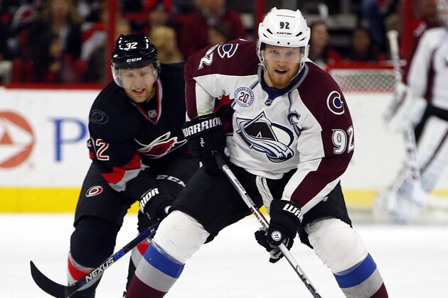 Colorado Avalanche's Gabriel Landeskog (92) of Sweden,  is challenged by Carolina Hurricanes' Kris Versteeg (32) during the first period of an NHL hockey game, Friday, Oct. 30, 2015, in Raleigh, N.C. (AP Photo/Karl B DeBlaker)