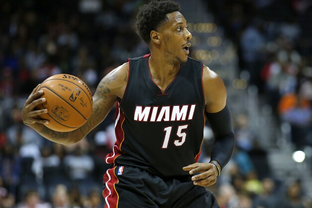 Miami Heat guard Mario Chalmers (15) looks to pass in the second half of a preseason NBA basketball game against the Atlanta Hawks on Sunday, Oct. 18, 2015, in Atlanta. The Heat won the game 101-92. (AP Photo/Todd Kirkland)