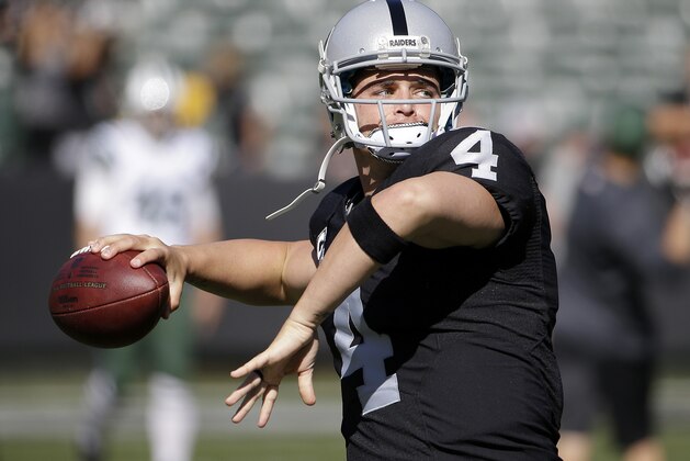 Oakland Raiders quarterback Derek Carr (4) warms up before an NFL football game against the New York Jets in Oakland, Calif., Sunday, Nov. 1, 2015. (AP Photo/Marcio Jose Sanchez)