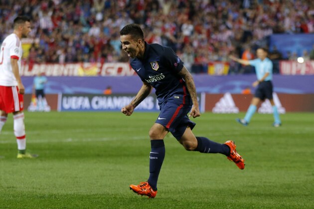 Atletico's Angel Correa celebrates after scoring the opening goal of his team during the Champions League group C soccer match between Atletico de Madrid and Benfica at the Vicente Calderon stadium in Madrid, Wednesday, Sept. 30, 2015. (AP Photo/Daniel Ochoa de Olza)
