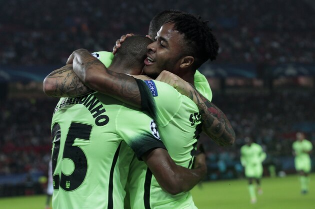 Manchester City's Raheem Sterling, right, celebrates with team mates after scoring the opening goal during the Group D Champions League soccer match between Sevilla and Manchester City at the Ramon Sanchez-Pizjuan stadium in Seville, Spain, Tuesday Nov. 3, 2015. (AP Photo/Miguel Angel Morenatti)