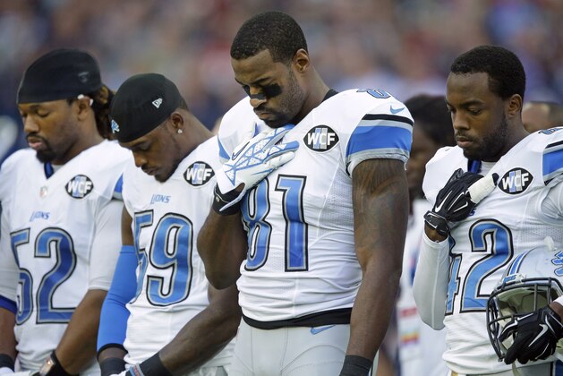 Detroit Lions wide receiver Calvin Johnson (81) pauses during the playing of the anthems before the NFL football game between Detroit Lions and Kansas City Chiefs Wembley Stadium in London,  Sunday, Nov. 1, 2015. (AP Photo/Matt Dunham)