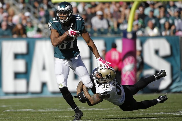 Philadelphia Eagles' Jordan Matthews, left, tries to break a tackle by New Orleans Saints' Kenny Vaccaro during the second half of an NFL football game, Sunday, Oct. 11, 2015, in Philadelphia. (AP Photo/Michael Perez)