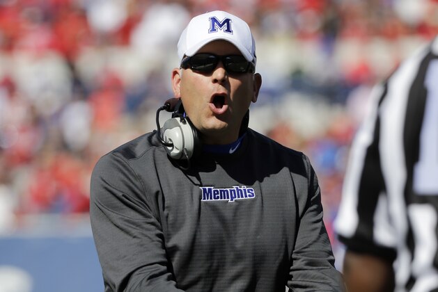 Memphis head coach Justin Fuente argues a call with line judge Will McDonald, right, in the second half of an NCAA college football game against Mississippi Saturday, Oct. 17, 2015, in Memphis, Tenn. Memphis upset No. 13 Mississippi 37-24. (AP Photo/Mark Humphrey)
