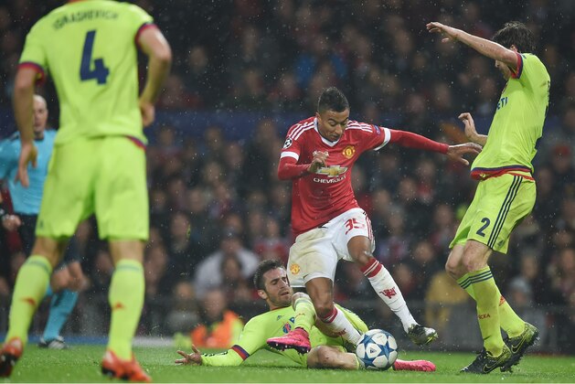 Manchester United's English midfielder Jesse Lingard (C) jumps a tackle by CSKA Moscow's midfielder from Serbia Zoran Tosic during a UEFA Chamions league group stage football match between CSKA Moscow and Manchester United at Old Trafford in Manchester, north west England on November 3, 2015. AFP PHOTO/PAUL ELLIS        (Photo credit should read PAUL ELLIS/AFP/Getty Images)