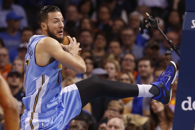 Denver Nuggets forward Joffrey Lauvergne grabs a rebound during an NBA basketball game between the Denver Nuggets and the Oklahoma City Thunder in Oklahoma City, Sunday, Nov. 1, 2015. Oklahoma City won 117-93. (AP Photo/Sue Ogrocki)